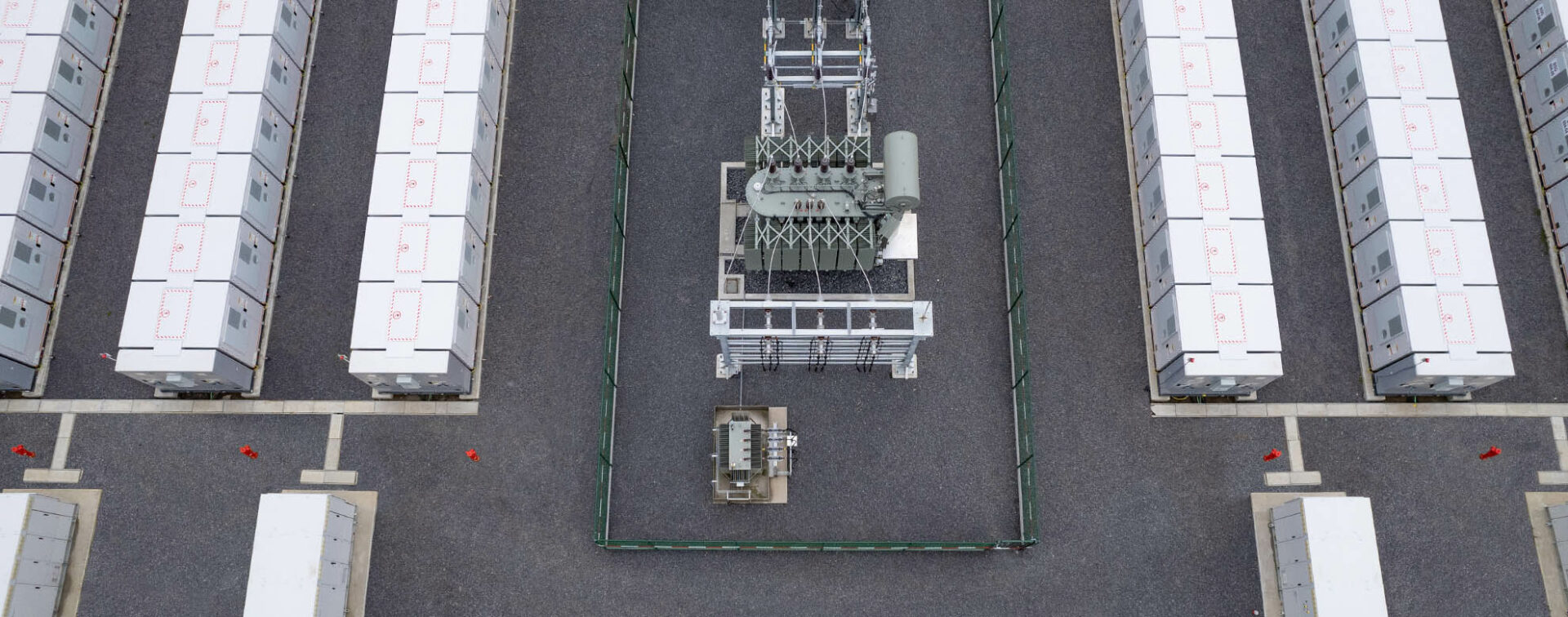 Battery energy storage system, aerial view; in the center a transformer station and electrical cables.