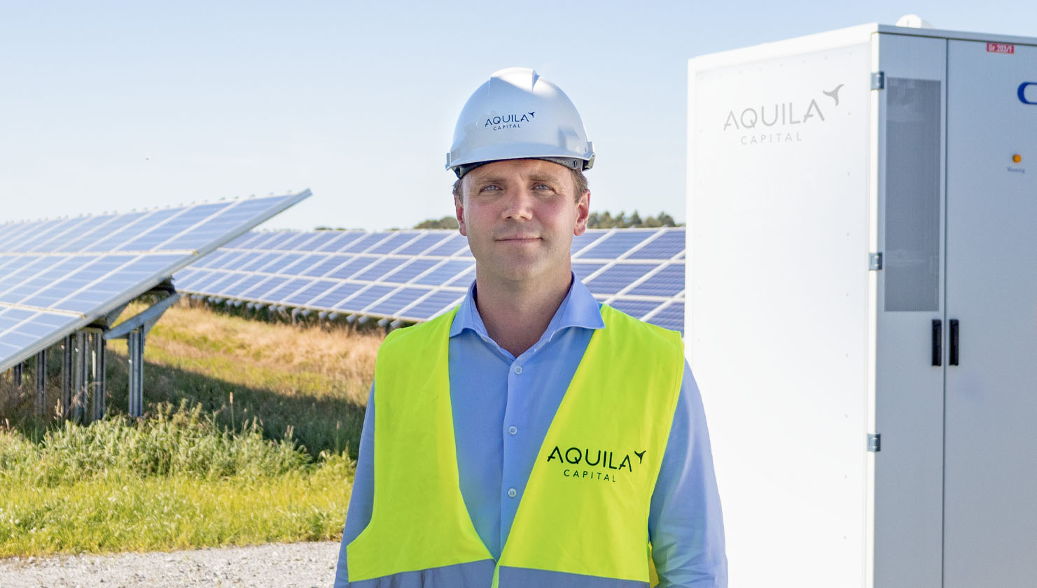 Kilian Leykam in front of battery storage system and solar pv park