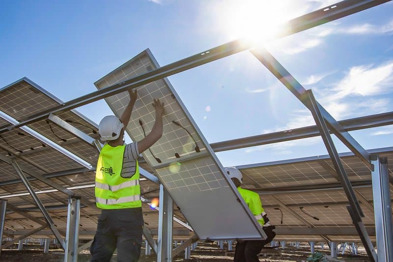 Worker installing a solar panel.